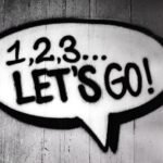 A black and white photo of a speech bubble that says 12 3 let's go related to computer support.