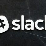 Slack logo with a hashtag icon on a dark, textured background.